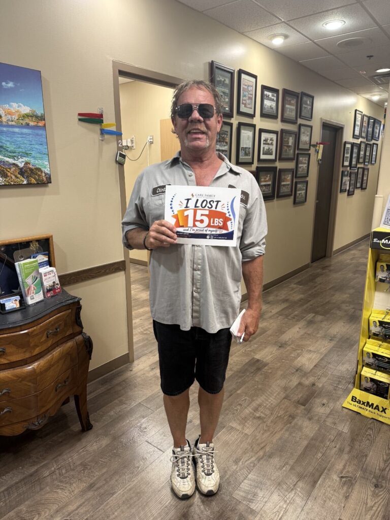 Care Family patient holding a sign that reads I lost 15 lbs and I am proud of myself